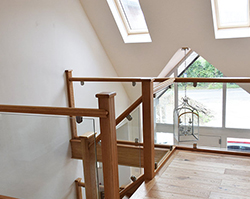 A stunning internal staircase made from clean wood and open glass.